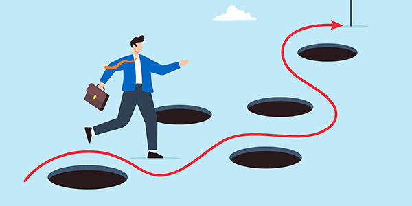 Graphic illustration of a businessman carrying a briefcase while walking along a winding red path that navigates around several dark pitfall holes toward a finish line flag.